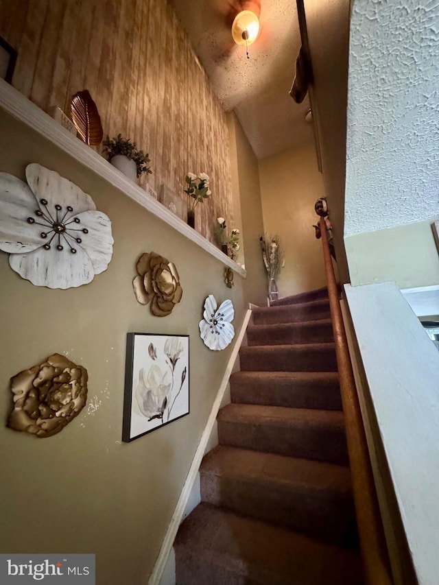 stairway featuring baseboards