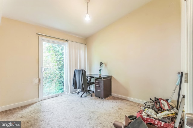 carpeted office featuring baseboards and vaulted ceiling