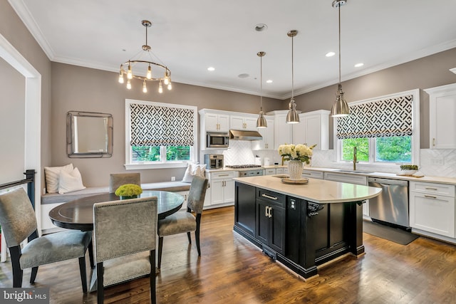 5526 Macarthur Blvd NW, Washington, DC 20016 - kitchen featuring stainless steel appliances, under cabinet range hood, dark cabinetry, white cabinets, and recessed lighting