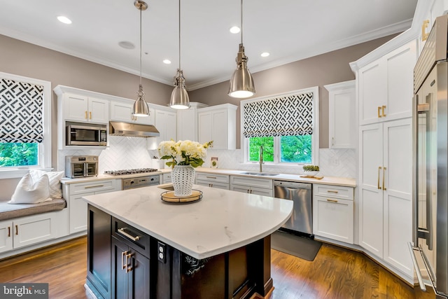 5526 Macarthur Blvd NW, Washington, DC 20016 - kitchen with stainless steel appliances, under cabinet range hood, white cabinets, ornamental molding, and recessed lighting