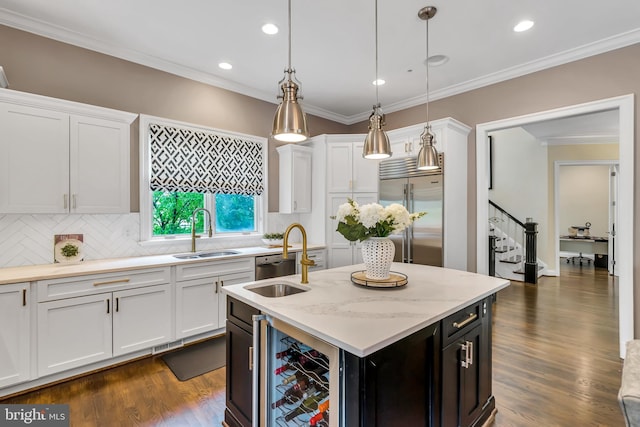 5526 Macarthur Blvd NW, Washington, DC 20016 - kitchen with appliances with stainless steel finishes, a sink, beverage cooler, a center island with sink, and white cabinetry