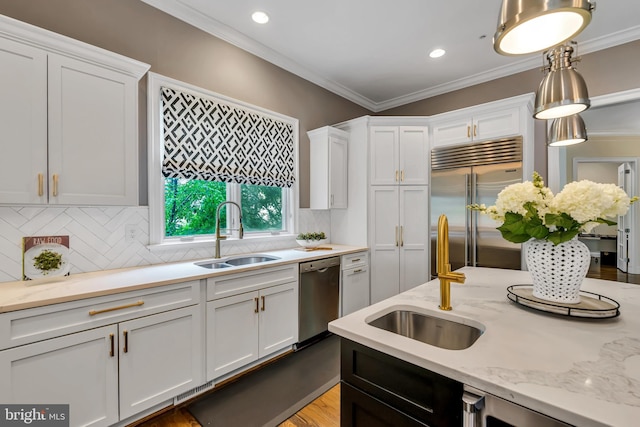 5526 Macarthur Blvd NW, Washington, DC 20016 - kitchen with stainless steel appliances, a sink, white cabinetry, decorative backsplash, and crown molding