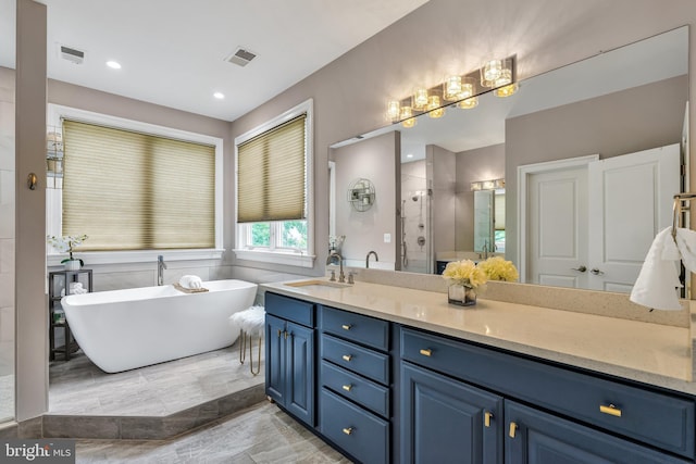 5526 Macarthur Blvd NW, Washington, DC 20016 - bathroom with a stall shower, vanity, a freestanding tub, marble finish floors, and recessed lighting