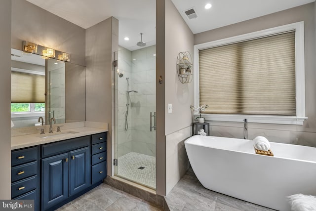 5526 Macarthur Blvd NW, Washington, DC 20016 - full bathroom featuring a stall shower, a freestanding tub, vanity, and recessed lighting