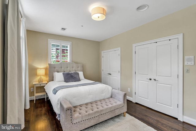 5526 Macarthur Blvd NW, Washington, DC 20016 - bedroom featuring multiple closets, wood finished floors, and baseboards