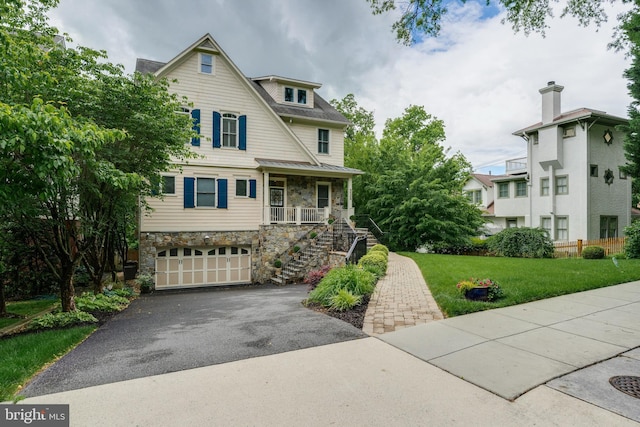 5526 Macarthur Blvd NW, Washington, DC 20016 - view of front facade with stairway, stone siding, covered porch, driveway, and a garage
