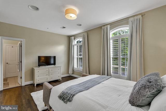 5526 Macarthur Blvd NW, Washington, DC 20016 - bedroom with multiple windows, wood finished floors, and baseboards