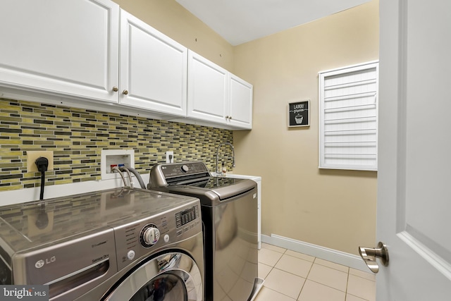 5526 Macarthur Blvd NW, Washington, DC 20016 - washroom featuring separate washer and dryer, cabinet space, light tile patterned flooring, and baseboards