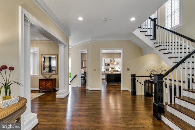 5526 Macarthur Blvd NW, Washington, DC 20016 - entrance foyer featuring wood finished floors, decorative columns, crown molding, recessed lighting, and baseboards