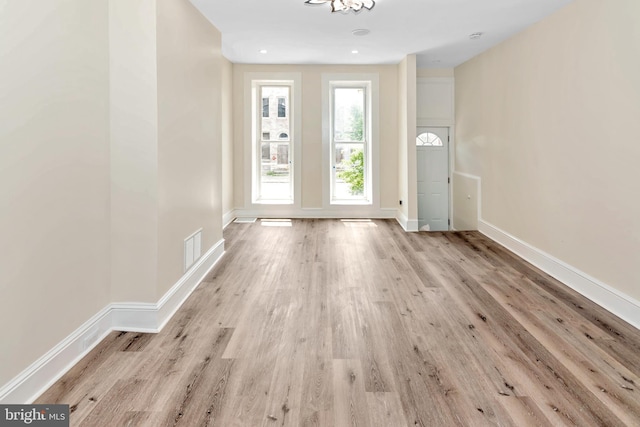 entrance foyer with wood finished floors and baseboards