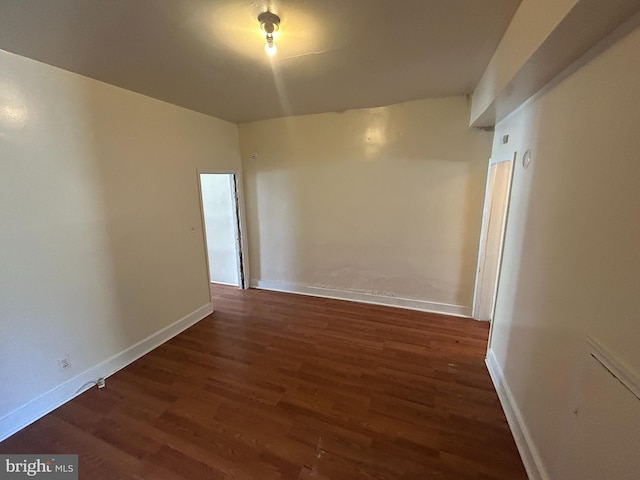 empty room with wood finished floors and baseboards