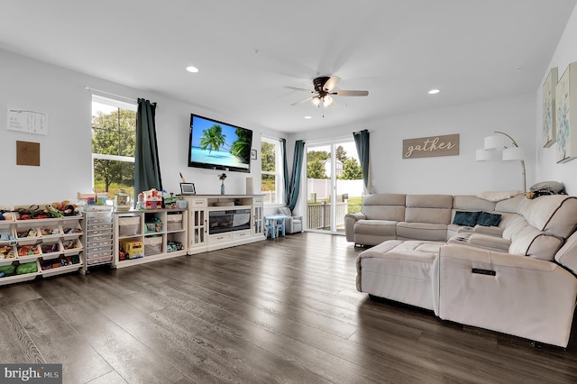 living area featuring a ceiling fan, healthy amount of natural light, recessed lighting, and dark wood-style flooring