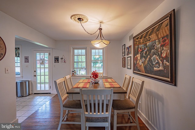 dining room with healthy amount of natural light and wood finished floors