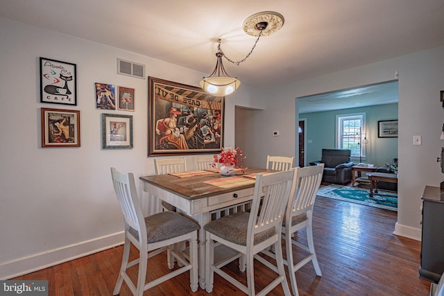dining area featuring wood finished floors and baseboards