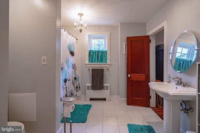 full bathroom with radiator, toilet, a chandelier, tile patterned floors, and baseboards