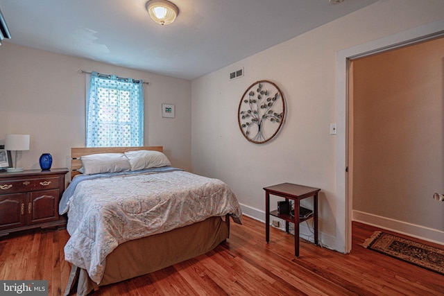 bedroom with wood finished floors and baseboards