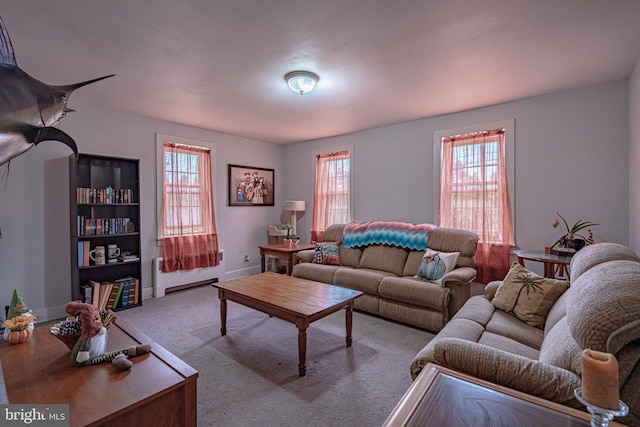 carpeted living room with radiator heating unit and baseboards