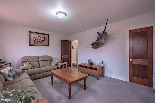 living area featuring carpet and baseboards