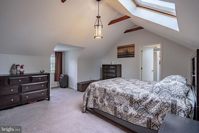 bedroom featuring a skylight, light carpet, and baseboards