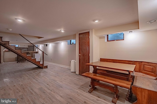 below grade area featuring light wood-style floors and stairway