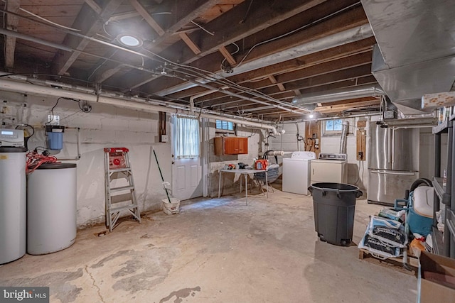 below grade area with a water softener, separate washer and dryer, and freestanding refrigerator