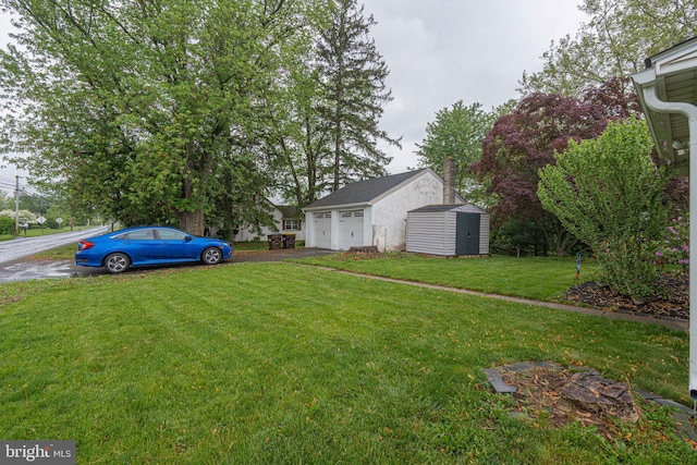 view of green lawn with an outbuilding, a detached garage, and a shed