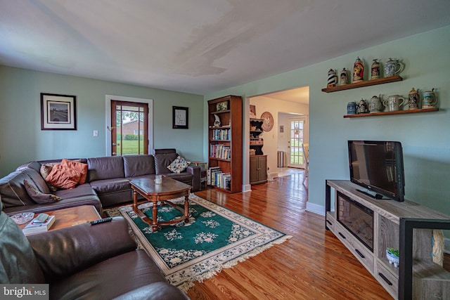 living area with wood finished floors and baseboards