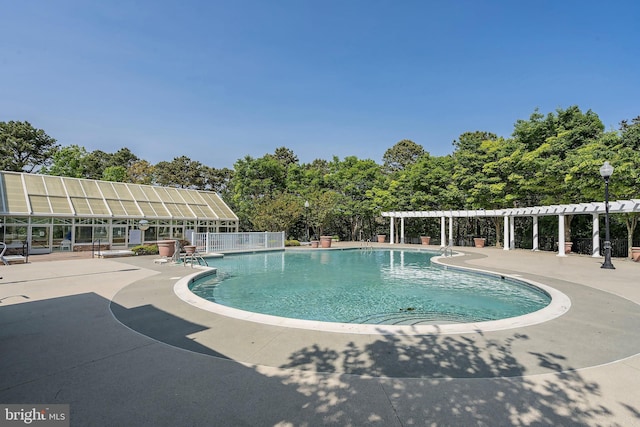 4 Augusta Dr, Little Egg Harbor Twp, NJ 08087 - community pool with a pergola, a patio area, view of scattered trees, and fence