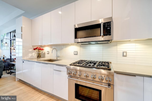 45 Sutton Sq SW Unit Ph11, Washington, DC 20024 - kitchen featuring appliances with stainless steel finishes, a sink, white cabinets, and modern cabinets