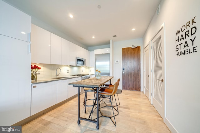 45 Sutton Sq SW Unit Ph11, Washington, DC 20024 - kitchen featuring stainless steel appliances, a sink, modern cabinets, white cabinetry, and recessed lighting