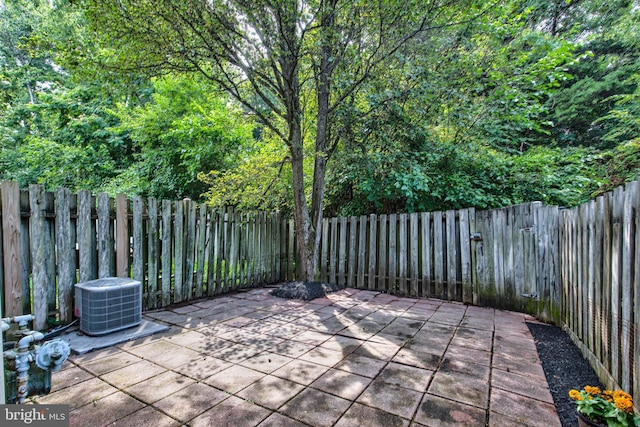 view of patio with central AC unit and a fenced backyard