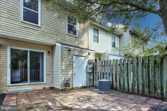 view of patio featuring central AC and fence