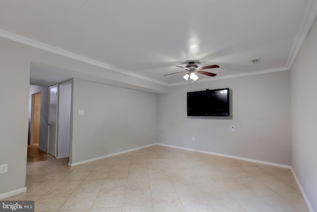 spare room with a ceiling fan, ornamental molding, and baseboards