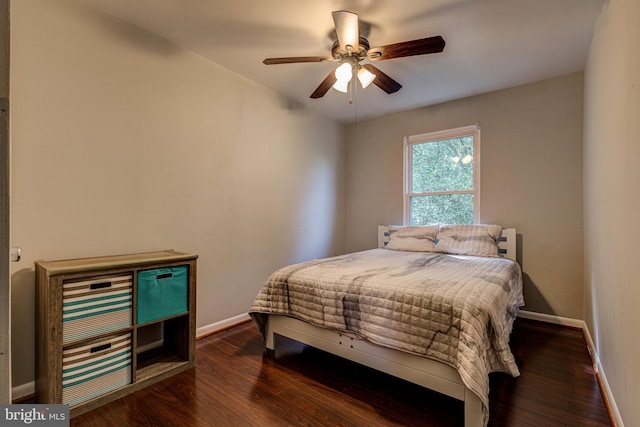 bedroom with dark wood-style floors, baseboards, and a ceiling fan