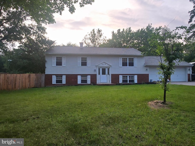 split foyer home with brick siding and an attached garage
