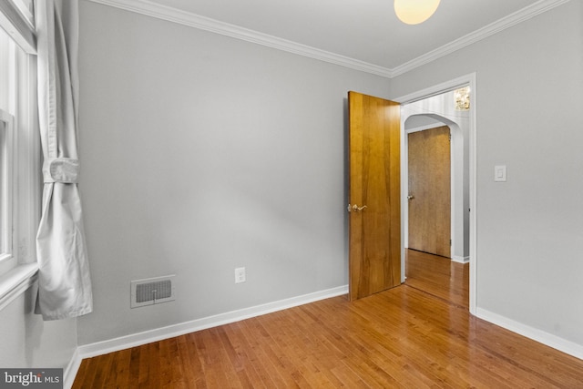 15 Renee, Lawrence Township, NJ 08648 - spare room with arched walkways, light wood finished floors, baseboards, and ornamental molding