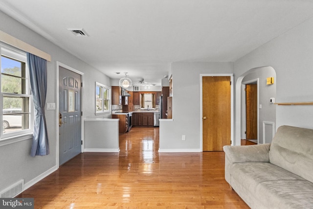 15 Renee, Lawrence Township, NJ 08648 - living area with arched walkways, light wood-style flooring, and baseboards