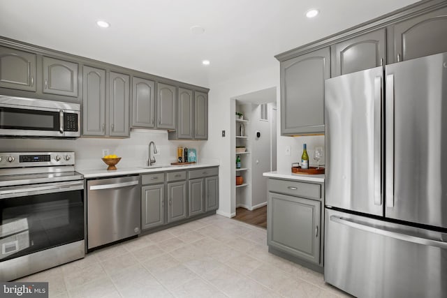 18165 Metz Dr, Germantown, MD 20874 - kitchen featuring stainless steel appliances, gray cabinets, light countertops, a sink, and recessed lighting