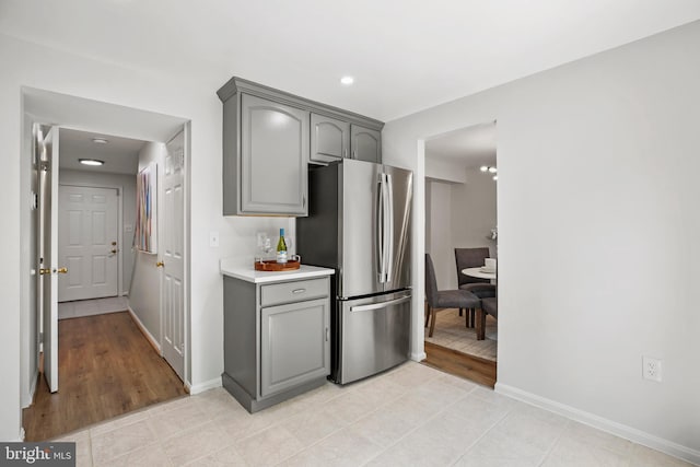 18165 Metz Dr, Germantown, MD 20874 - kitchen with freestanding refrigerator, gray cabinets, light countertops, baseboards, and recessed lighting
