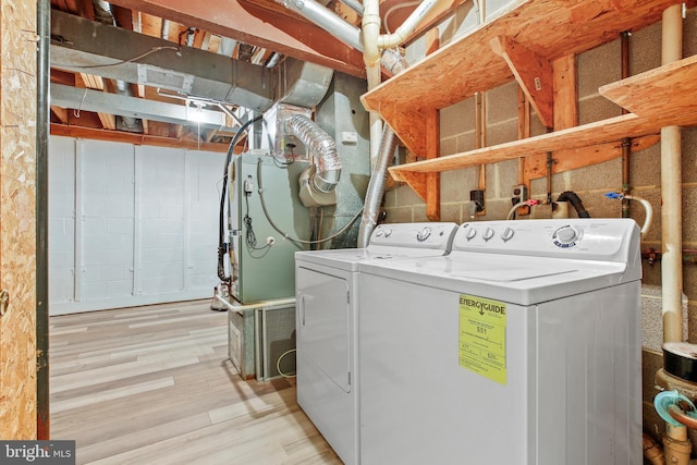 18165 Metz Dr, Germantown, MD 20874 - washroom with washer and clothes dryer and light wood-style flooring