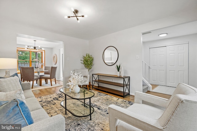 18165 Metz Dr, Germantown, MD 20874 - living area featuring a chandelier, wood finished floors, baseboards, and stairs
