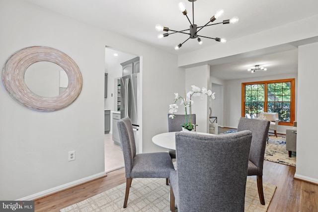 18165 Metz Dr, Germantown, MD 20874 - dining space with a chandelier, wood finished floors, and baseboards