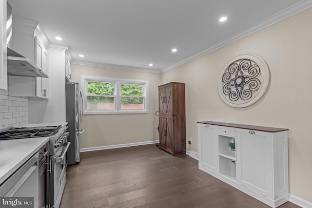669 Worthington Dr, Warminster, PA 18974 - kitchen with appliances with stainless steel finishes, wall chimney range hood, white cabinets, crown molding, and dark wood finished floors