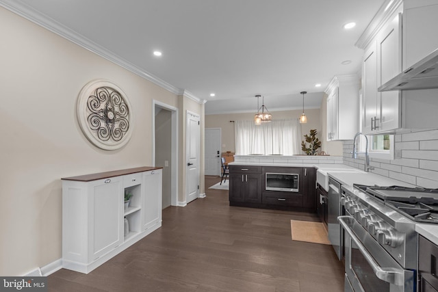 669 Worthington Dr, Warminster, PA 18974 - kitchen featuring appliances with stainless steel finishes, a peninsula, white cabinets, wall chimney range hood, and light countertops