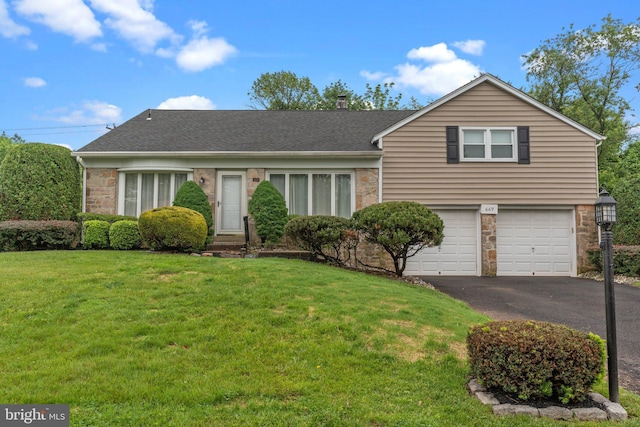 669 Worthington Dr, Warminster, PA 18974 - view of front of house with a garage, asphalt driveway, a front yard, and a shingled roof