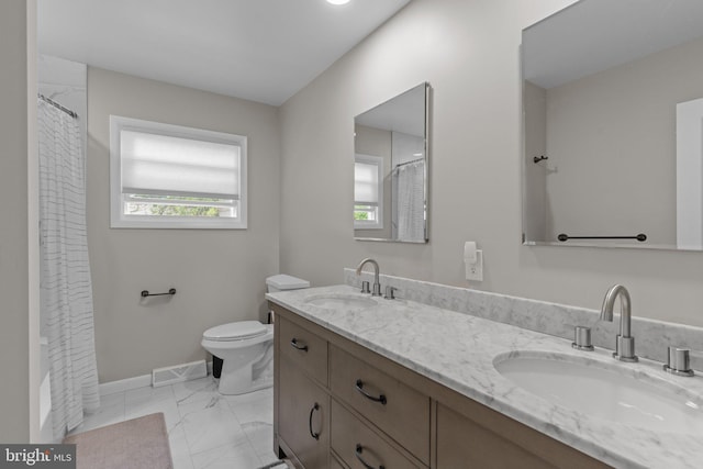 669 Worthington Dr, Warminster, PA 18974 - bathroom with double vanity, toilet, marble finish flooring, curtained shower, and baseboards