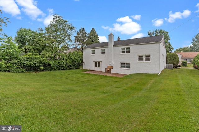 669 Worthington Dr, Warminster, PA 18974 - back of property featuring a chimney, a lawn, central air condition unit, and a patio area