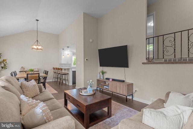 669 Worthington Dr, Warminster, PA 18974 - living area with wood finished floors, a chandelier, lofted ceiling, and baseboards