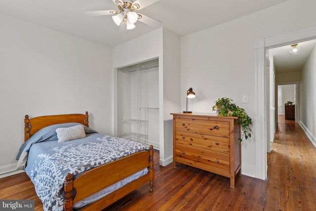 bedroom with hardwood / wood-style flooring, baseboards, a closet, and ceiling fan
