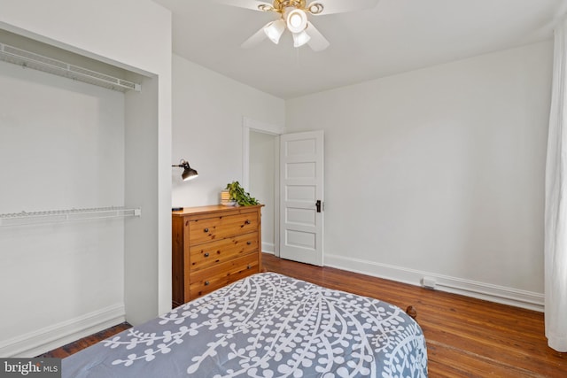 bedroom with baseboards, wood finished floors, and a ceiling fan